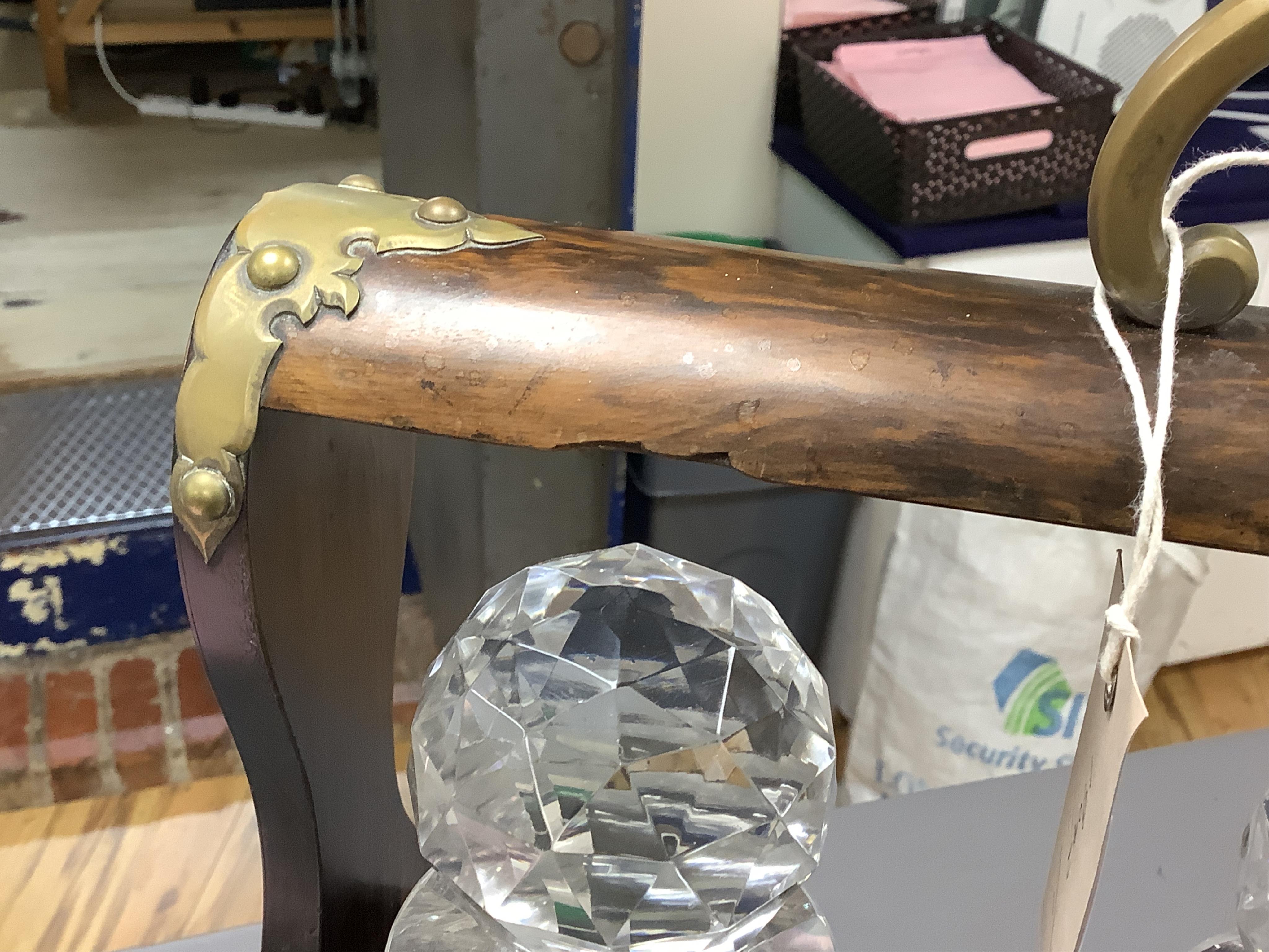 A Victorian coromandel three-bottle tantalus with brass mounts and original key